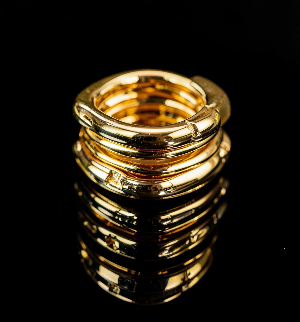 Gold jewellery arranged on stone